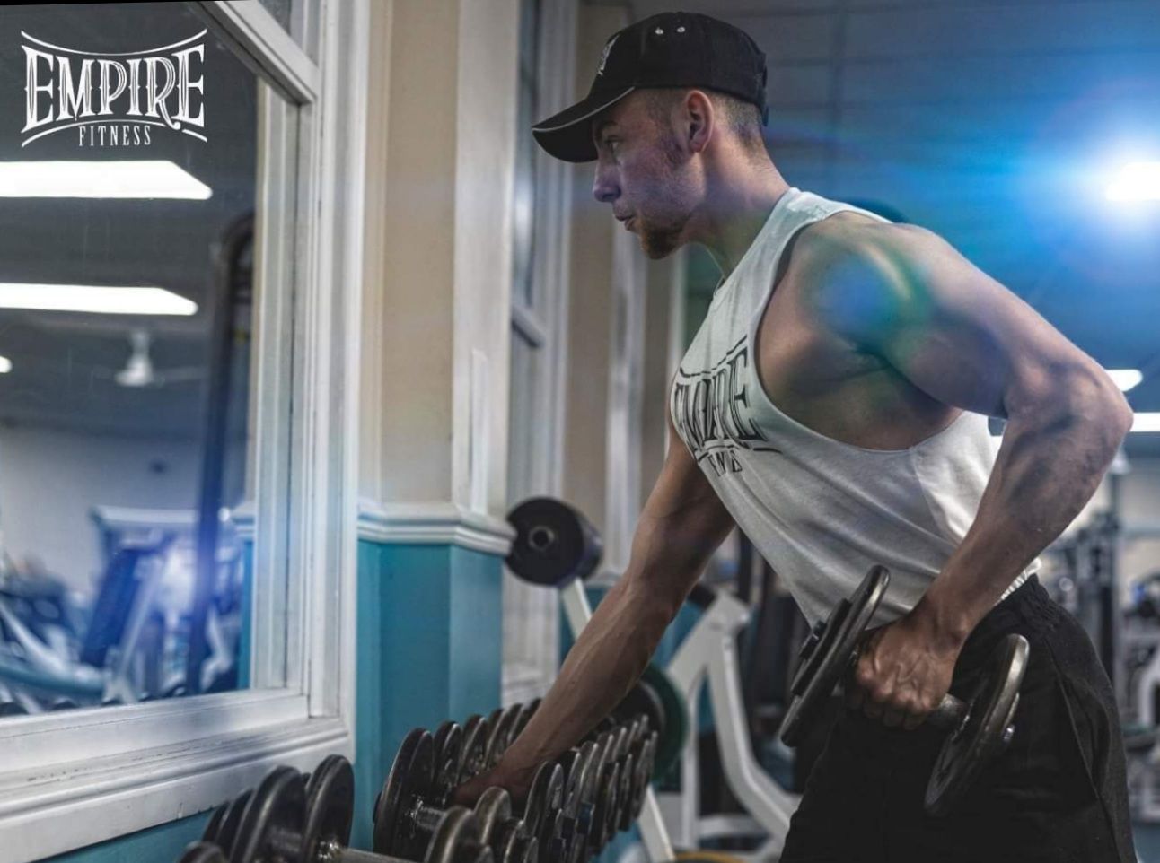 James Whiting lifting a dumbbell beside the free weights at Empire Fitness in Hinckley